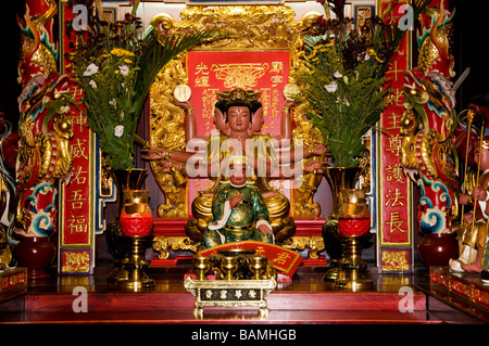 ALTAR MIT ORIENTALISCHEN GOTT MIT DREI GESICHTERN SECHS ARME IN GOLD & ROT VERZIERT Stockfoto