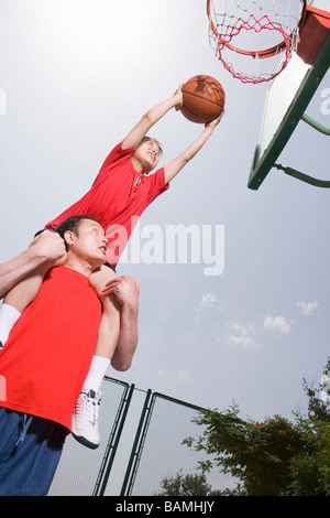 Vater und Sohn spielen Basketball Stockfoto