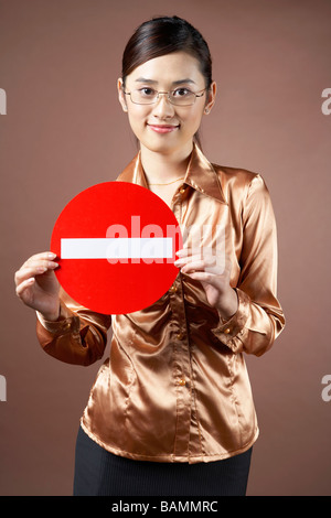 Junge Frau hält ein Straße Zeichen Stockfoto