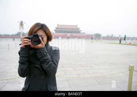 Junge Frau, die ein Foto vor dem Tiananmen-Platz, Peking, China Stockfoto