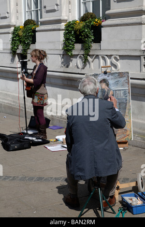 Streetart-Künstler ein Bild des weiblichen busker Stockfoto