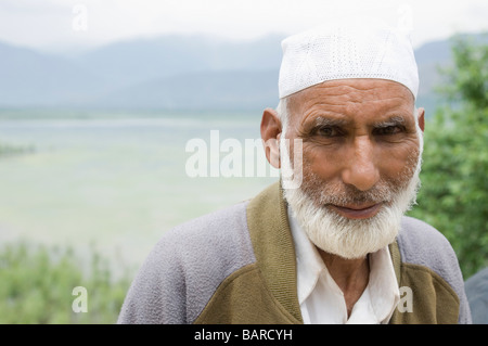 Porträt eines Mannes mit einem See im Hintergrund, Wullar See, Jammu und Kaschmir, Indien Stockfoto
