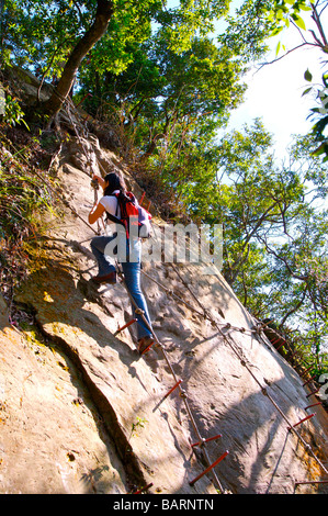 Junge Frau Klettern Fels-Seitenansicht Stockfoto