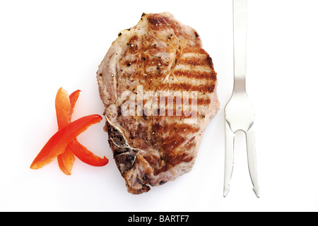 Gegrilltes Schweinekotelett und Fleischgabel, erhöhten Blick Stockfoto