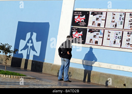 Ein Mann betrachtet ein Poster mit einer Beschreibung der Geschichte der großen Hungersnot (Holodomor) an einem Denkmal in der Nähe von Kloster St. Michael in Kiew Stockfoto