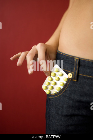 junge Frau mit einem Blister Tabletten in Tasche Stockfoto