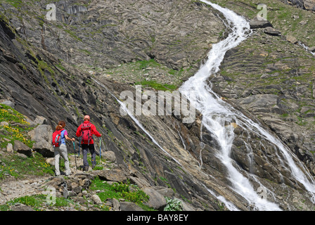 junges Paar auf Trail mit Blick zum Streamen, Aufstieg zur Hütte Schwarzenberghuette, hohen Tauern Bereich, Nationalpark Hohe Tauern, Salz Stockfoto