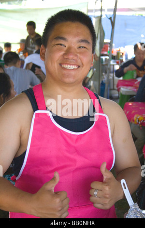 Glücklich Teenager Koch im Restaurant unter freiem Himmel Hmong. Hmong Sport Festival McMurray Feld St Paul Minnesota USA Stockfoto