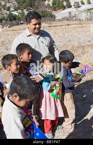 Kleinkinder erhalten Obst und Schule Lieferungen als Geschenke in die Tarahumara Dorf von San Alonso in Copper Canyon Mexiko gegeben Stockfoto