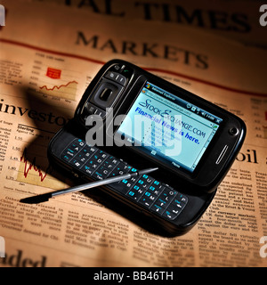 HANDY-PDA-INTERNET-ZUGANG MIT FINANZIELLEN ZEITUNGSSEITE Stockfoto