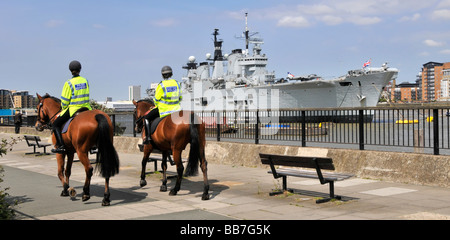 Königliche Marine Kriegsschiff HMS Illustrious leichte Flugzeugträger am Rande des Flusses Themse Greenwich London vor Anker montiert Polizeistreife Stockfoto