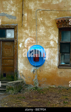 Telefon an der Wand des alten Hauses. Tür und Fenster um Telefon. Stockfoto