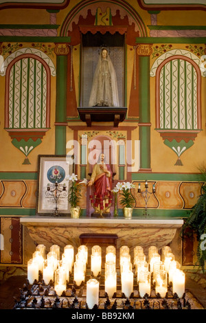 San Juan Bautista CA alte Mission San Juan Bautista 1797 Innenraum Detail mit Statue von Jesus und devotional Kerzen Stockfoto