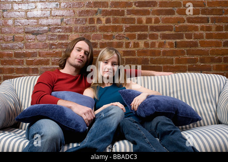 Porträt eines jungen Paares sitzen auf einem sofa Stockfoto