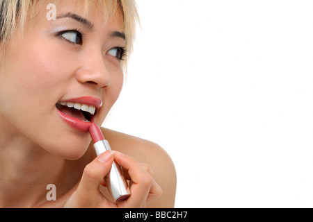 Eine junge Frau gilt Lippenstift Stockfoto
