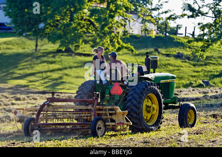 Bauer und seine Frau auf John Deere 3010 Diesel-Traktor im Harrison County Indiana Stockfoto