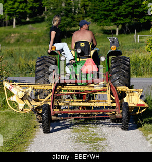 Bauer und seine Frau auf John Deere 3010 Diesel-Traktor im Harrison County Indiana Stockfoto