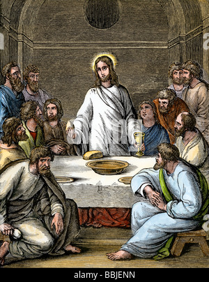 Jesus bricht das Brot beim Abendmahl mit den Aposteln. Hand - farbige Holzschnitt Stockfoto