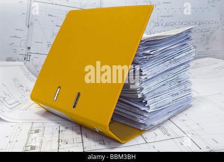 Gelbe Dateiordner mit Einzelblatt-Briefpapier. Projekt und Entwurfszeichnungen Stockfoto