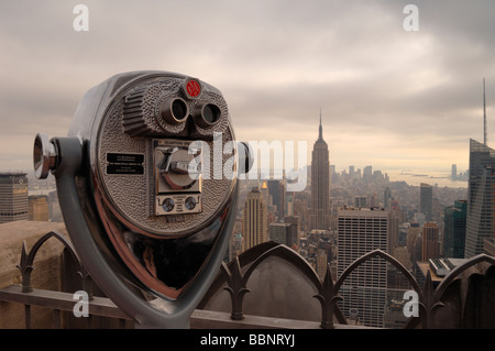Sucher-Ferngläser mit der New York Skyline im Hintergrund am oberen Rand der Felsen Suche New York City-NY-USA Stockfoto