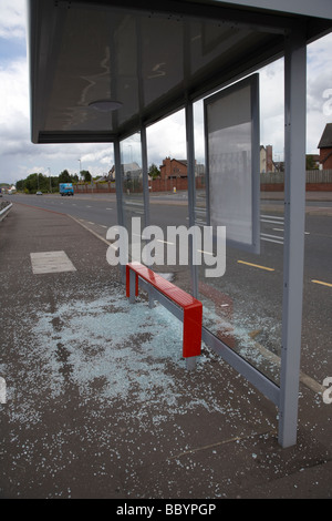 zerbrochene Glas auf dem Boden aus einem geschändeter Bushäuschen in Nordirland Stockfoto