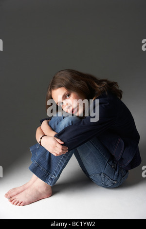 Nachdenklich Mädchen sitzen im Studio Stockfoto