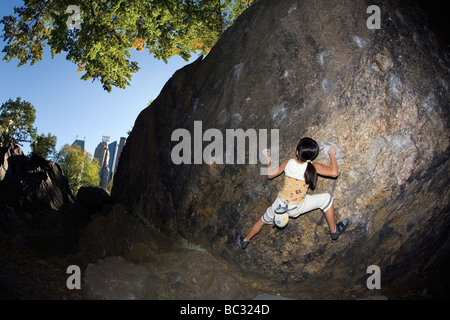 Ein junger Kletterer Bouldern im Central Park. Stockfoto