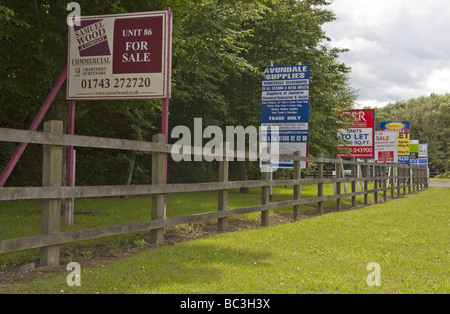 Mehrere "For Sale" und "Lassen Sie" Schilder entlang der Straße in einem Gewerbegebiet-Standort in Zeiten der wirtschaftlichen Rezession Stockfoto