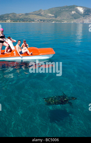 Familie auf Tretboot beobachten Unechte Karettschildkröte (Caretta Caretta) Laganas Bay, Zakynthos/Zante Griechenland Stockfoto