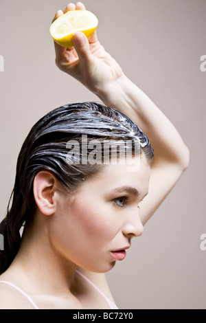 Frau, die Zitrone auf das Haar auftragen Stockfoto