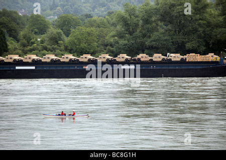 Humvee Fahrzeuge auf Transport entlang des Rheins beobachtete staunend von zwei Personen in einem Kajak Deutschland Europa Stockfoto