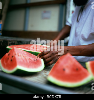 Ein Mann zerschneiden Wassermelone auf der Rückseite eines LKW auf den Straßen von Harlem New York KATHY DEWITT zu verkaufen in Florida angebaut Stockfoto