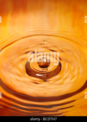 Wassertropfen fallen auf die Wasseroberfläche. Stockfoto