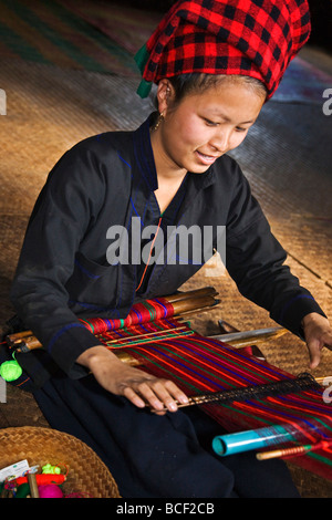 Myanmar, Burma, Lake Inle. Eine hübsche Frau Pa-O webt bunten Material Kya-Toon Village. Stockfoto