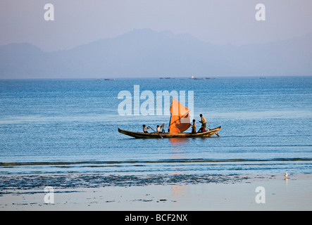 Myanmar, Burma, Rakhine-Staat. Nach einem atemberaubenden Sonnenuntergang, eilt die Besatzung eines kleinen Fischerbootes nach Hause. Stockfoto