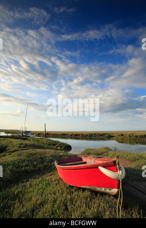 Ein rotes Ruderboot ruht auf den Sumpf am Dornweiler an der North Norfolk-Küste. Stockfoto