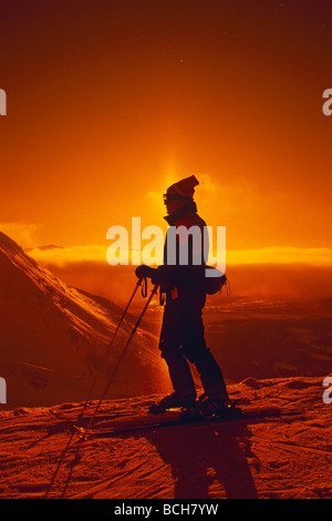 Skifahrer Silhouette w/Sun Dog auf Mt Alyeska SC AK Winter Backlit Stockfoto