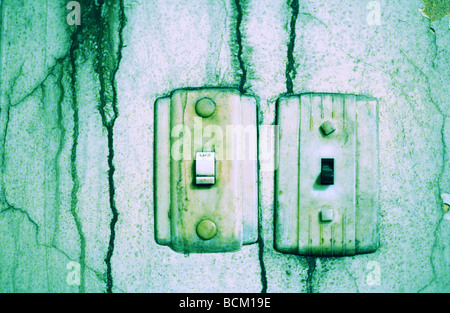 Lightswitches auf schmutzigen Wand, grün getönt Stockfoto