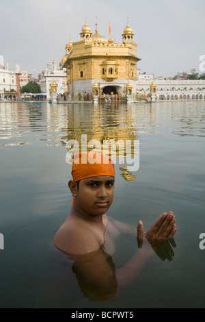 Sikh Mann taucht in den Gewässern – Sarovar (Wassertank) – um den goldenen Tempel (Sri Harmandir Sahib) Amritsar. Punjab. Indien Stockfoto