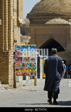 Usbekische Mann zu Fuß vom Restaurant Menü Zeichen in Buchara Usbekistan Stockfoto