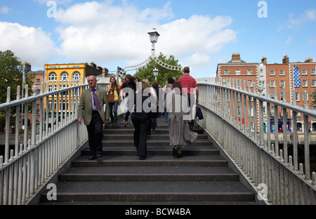 Fußgänger überqueren die Halfpenny Hapenny Brücke über den Fluss Liffey im Zentrum von Dublin Stadt der Republik Irland Stockfoto