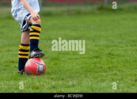 Junge Fußballer einen Fuß auf den ball im Fußball-Praxis ruhen. Stockfoto