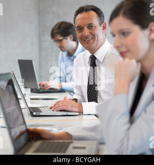 Geschäftsmann mit Laptop, Lächeln Stockfoto