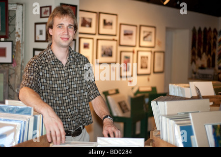 junges Unternehmen Galerie Eigentümer oder Mitarbeiter stehen in der Retail-Galerie zeigt die Ware zum Verkauf Stockfoto