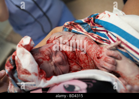 Ein neugeborenes Baby junge ist in den Armen seiner Mutter gewiegt. Stockfoto