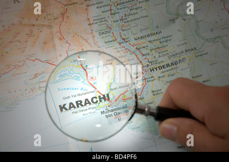 Zeigen Sie mit einem Finger die Stadt Karachi auf einer Karte an Stockfoto