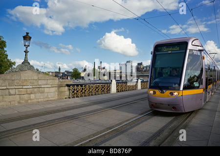 LUAS Tram auf Sean Heuston Brücke über den Fluss Liffey mit Guinness-Brauerei in Ferne Stadt Dublin, Irland Stockfoto