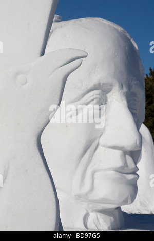 Der Rabe und Sir John A. Macdonald Schneeskulpturen. Eine leise konzentriert, riesige Büste von Kanadas erster Ministerpräsident hinter einem Raben Stockfoto