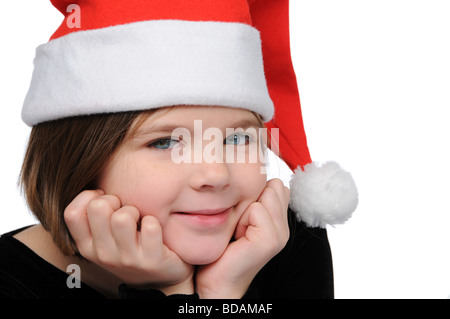 Kleines Mädchen mit Weihnachtsmütze s isoliert auf weiss Stockfoto