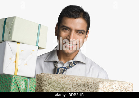 Geschäftsmann hält Geschenkboxen Stockfoto